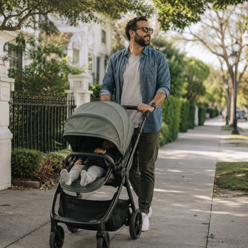 Man pushing a stroller with a child on a sidewalk in a residential area